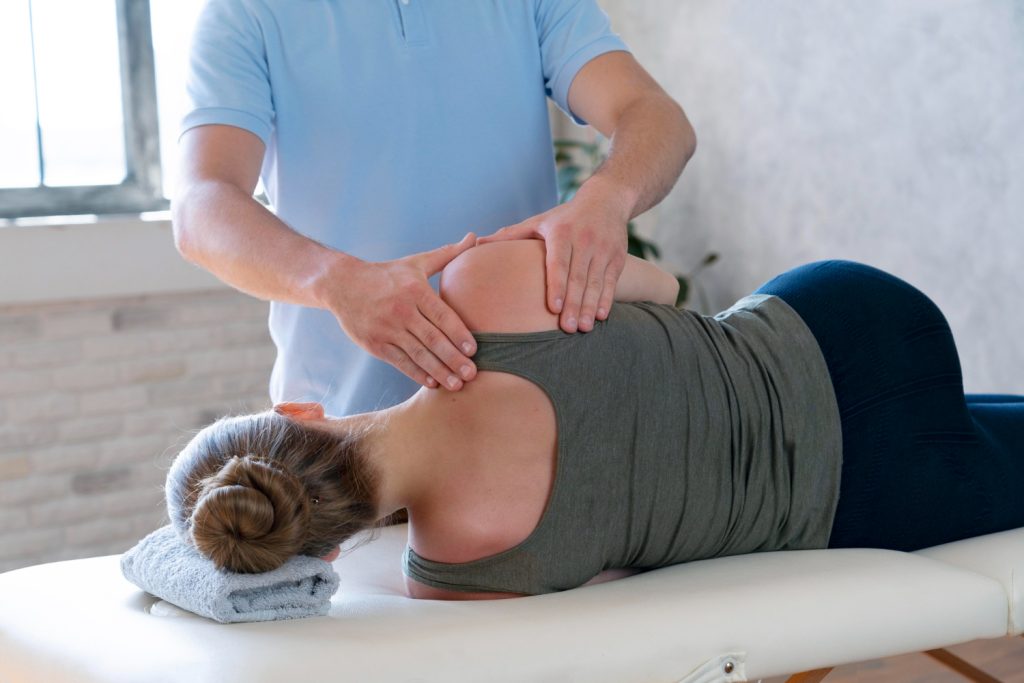 Patient receiving a shoulder alignment check to relieve pain and restore function.